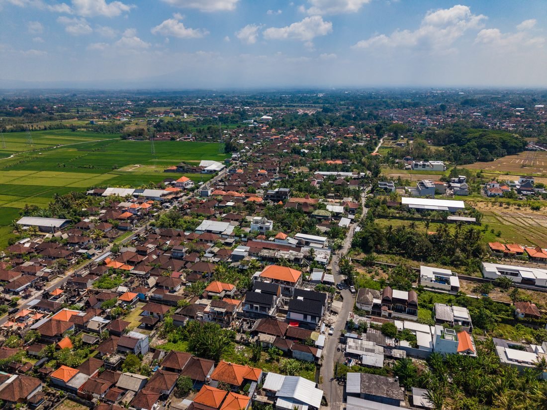 Aerial photograph over the Kedungu area showing the village, rice fields and the coast beyond